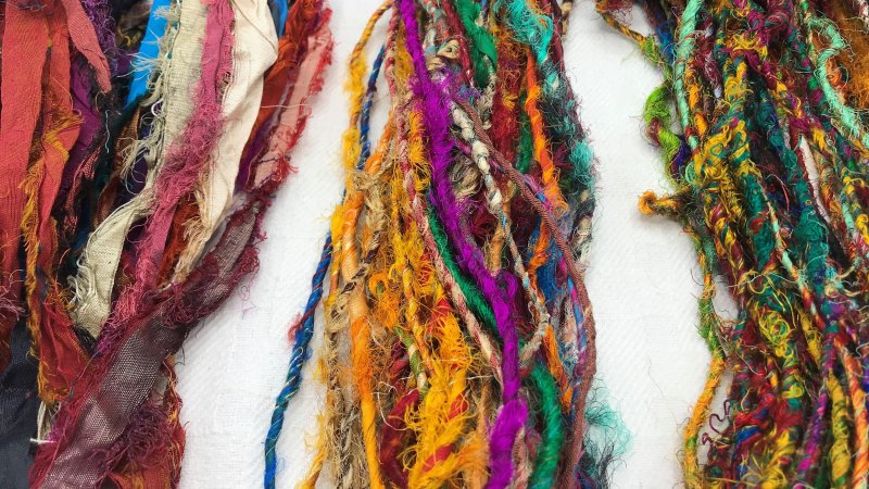 Sari Silk Ribbons (Left), Sari Silk Yarn (Center), Recycled Silk Yarn (Right)