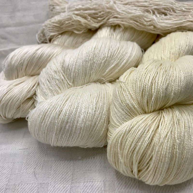 Top/horizonal:  Shanta (hand-spun eri silk), L-R: Kiku (20/2 bombyx silk), Omshanti-White (20/2 Eri Silk), Omshanti-Red (20/2 Eri Silk)