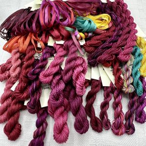 Silk threads and ribbons in Garnet colors.  Why are there more colors than red?  Because the garnet stone comes in a wide variety of colors beyond red.